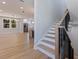 Open-concept interior view featuring a staircase, kitchen, and living area at 1811 Bayou Grande Ne Blvd, St Petersburg, FL 33703