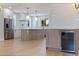 Bright kitchen with stainless steel appliances, large island, and beverage refrigerator at 1811 Bayou Grande Ne Blvd, St Petersburg, FL 33703