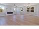 Bright and airy living room with hardwood floors, modern fireplace, and an abundance of natural light at 1811 Bayou Grande Ne Blvd, St Petersburg, FL 33703