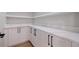 A well-organized butler's pantry with quartz countertops and custom white cabinetry at 1811 Bayou Grande Ne Blvd, St Petersburg, FL 33703