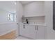 Contemporary style sink with white shaker cabinets, marble countertop, sleek black hardware, and next to the stairway at 1811 Bayou Grande Ne Blvd, St Petersburg, FL 33703