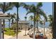 Panoramic view of waterfront property, palm trees, and a two-story house at 1811 Bayou Grande Ne Blvd, St Petersburg, FL 33703