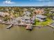 Aerial view of a waterfront home with a private dock, patio, and lush landscaping at 1819 Bayou Grande Ne Blvd, St Petersburg, FL 33703