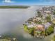 Aerial view showcases a waterfront home with docks, tropical landscaping, and bay access at 1819 Bayou Grande Ne Blvd, St Petersburg, FL 33703