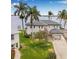 Beautiful two-story waterfront home featuring a two-car garage and mature palm trees at 1819 Bayou Grande Ne Blvd, St Petersburg, FL 33703
