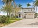 Two-story waterfront home features a two-car garage and landscaped yard at 1819 Bayou Grande Ne Blvd, St Petersburg, FL 33703
