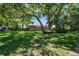 Spacious backyard with mature trees offering ample shade and privacy at 1940 Floresta View Dr, Tampa, FL 33618