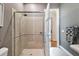 Bathroom featuring tile shower with glass door, tile floors, and neutral paint at 1940 Floresta View Dr, Tampa, FL 33618