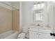 Clean bathroom with neutral tile, a bathtub and shower combination, and ample vanity storage at 1940 Floresta View Dr, Tampa, FL 33618