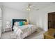 Inviting bedroom with a blue headboard, bright natural light, and fresh white walls at 1940 Floresta View Dr, Tampa, FL 33618
