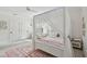 Cozy bedroom featuring a canopy bed, soft lighting, and shuttered windows at 1940 Floresta View Dr, Tampa, FL 33618