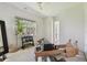 Bonus room is flooded with light and features a ceiling fan, gym equipment, and neutral carpet at 1940 Floresta View Dr, Tampa, FL 33618