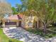 Beautiful two-story home featuring mature landscaping and attached garage at 1940 Floresta View Dr, Tampa, FL 33618