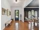 Bright foyer featuring hardwood floors, white walls, high ceilings, and decorative light fixtures at 1940 Floresta View Dr, Tampa, FL 33618