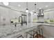 Modern kitchen showcasing granite countertops, white cabinetry, stainless appliances, and a kitchen island at 1940 Floresta View Dr, Tampa, FL 33618