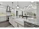 Open kitchen featuring white cabinetry, granite countertops, and modern appliances, great for cooking at 1940 Floresta View Dr, Tampa, FL 33618