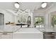 Kitchen island features white farmhouse sink, granite countertops and modern pendant lighting and open floorplan at 1940 Floresta View Dr, Tampa, FL 33618