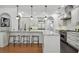 Gourmet kitchen featuring granite countertops, stainless steel appliances, and modern pendant lighting at 1940 Floresta View Dr, Tampa, FL 33618
