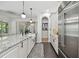 Bright kitchen boasts stone countertops, stainless appliances, and a seamless connection to the dining area at 1940 Floresta View Dr, Tampa, FL 33618