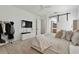 Light-filled main bedroom features modern minimalist decor, including a barn door detail and mounted television at 1940 Floresta View Dr, Tampa, FL 33618
