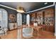 Stylish home office featuring custom built-ins, a striking light fixture, and wood floors at 1940 Floresta View Dr, Tampa, FL 33618