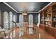 Sophisticated home office with dark walls, built-in bookshelves, and bright, natural light at 1940 Floresta View Dr, Tampa, FL 33618