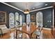 Home office showcasing dark walls, built-in shelves, hardwood floors and an elegant desk setup at 1940 Floresta View Dr, Tampa, FL 33618