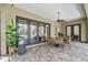 Patio area with dining table and chairs overlooking an inviting screened-in pool at 1940 Floresta View Dr, Tampa, FL 33618
