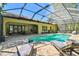 Inviting screened-in pool area features comfortable lounge chairs and a well-maintained patio at 1940 Floresta View Dr, Tampa, FL 33618