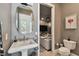 A well-lit powder room with an adjacent basement living room at 1940 Floresta View Dr, Tampa, FL 33618
