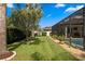 Well-manicured backyard with lush green lawn, mature trees, and a screened-in pool at 19830 Strathmore Pl, Land O Lakes, FL 34638