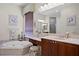 Bathroom with a garden tub, double vanity, framed art, and a dressing table at 19830 Strathmore Pl, Land O Lakes, FL 34638