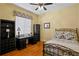 Bedroom with a decorative bed frame, a ceiling fan, and a built-in desk at 19830 Strathmore Pl, Land O Lakes, FL 34638