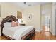 Comfortable bedroom featuring hardwood floors, natural light, and a decorative wood frame bed at 19830 Strathmore Pl, Land O Lakes, FL 34638