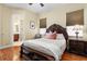 Inviting bedroom with wood floors, a decorative bed, and a serene atmosphere at 19830 Strathmore Pl, Land O Lakes, FL 34638
