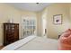 Bright bedroom offering natural light, wooden floors, and a lovely view of the outside patio at 19830 Strathmore Pl, Land O Lakes, FL 34638