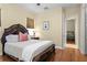 Cozy bedroom with a carved-wood bed, warm lighting, and hardwood floors at 19830 Strathmore Pl, Land O Lakes, FL 34638