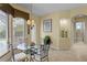 Bright breakfast nook with chandelier, large windows, and pool view at 19830 Strathmore Pl, Land O Lakes, FL 34638