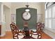 Dining room features an elegant glass-top table, wood chairs, and stylish decor at 19830 Strathmore Pl, Land O Lakes, FL 34638
