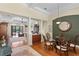 Open-concept dining room with hardwood floors, pillars, and elegant lighting, flowing to the living spaces at 19830 Strathmore Pl, Land O Lakes, FL 34638