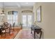 Bright foyer features tile flooring, arched windows, and French doors with transom windows at 19830 Strathmore Pl, Land O Lakes, FL 34638