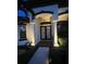 Home entryway with double doors, custom sidelights, architectural columns, and professional landscaping at 19830 Strathmore Pl, Land O Lakes, FL 34638