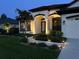 Manicured front yard and attractive home exterior with professional landscaping and walkway with custom lighting at 19830 Strathmore Pl, Land O Lakes, FL 34638