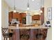 Open kitchen design with granite countertops, wooden cabinets and breakfast bar at 19830 Strathmore Pl, Land O Lakes, FL 34638