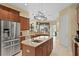 Kitchen with granite countertops, stainless steel appliances, wood cabinets, and a central island at 19830 Strathmore Pl, Land O Lakes, FL 34638