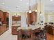 Gourmet kitchen with wooden cabinets, granite countertops, and stainless appliances at 19830 Strathmore Pl, Land O Lakes, FL 34638