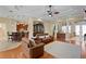 Open-concept living room with tray ceilings, hardwood floors, and view to kitchen at 19830 Strathmore Pl, Land O Lakes, FL 34638