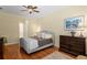Well-lit main bedroom with wooden floors and ensuite bathroom access at 19830 Strathmore Pl, Land O Lakes, FL 34638