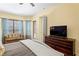 Bright main bedroom featuring an entertainment center, sitting area, and natural light at 19830 Strathmore Pl, Land O Lakes, FL 34638