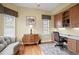 Cozy home office with built-in desk, storage cabinets, and a comfortable seating area at 19830 Strathmore Pl, Land O Lakes, FL 34638